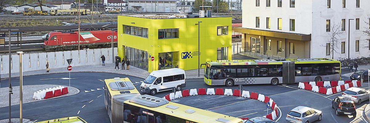 Two busses at a roundabout in front of the Infopoint in Bolzano/Bozen. Aer