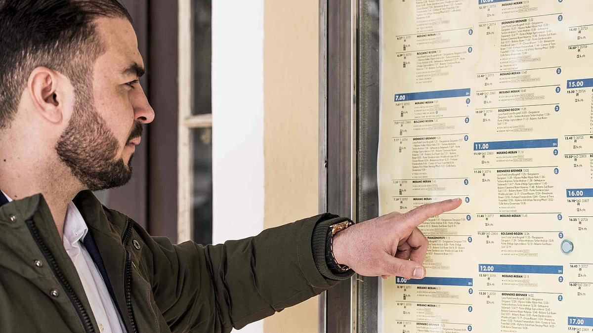 A man is checking the timetables